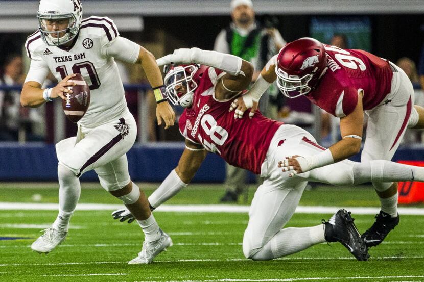 Texas A&M Aggies quarterback Kyle Allen (10) escapes a sack by Arkansas Razorbacks defensive...