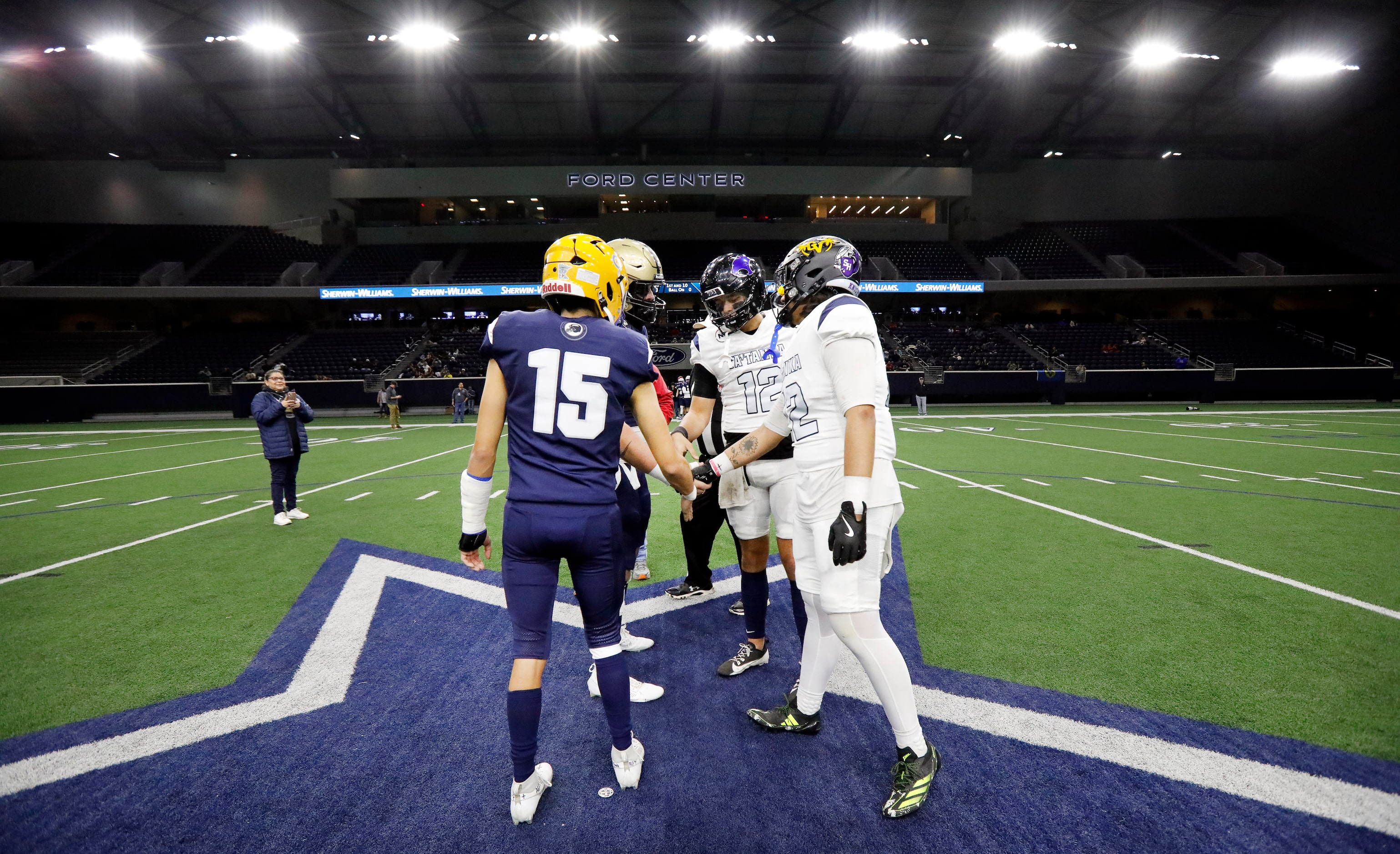 Following the ceremonial coin toss, Wa-Ya captain Joseph Earl (15) and Ta’ Tanka captain...