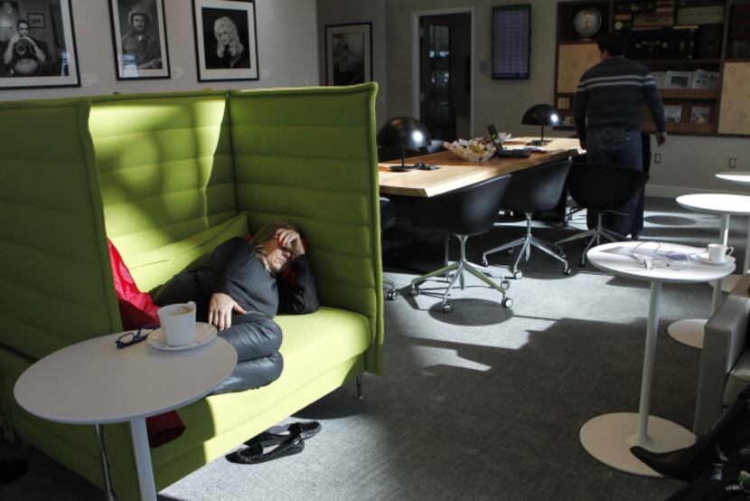 Luciana Encarnacao naps in the American Express Centurion Lounge at D/FW Airport while on a...