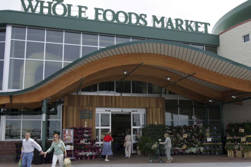 Customers are seen outside a Whole Foods Market in Dallas, Wednesday, May 9, 2007.