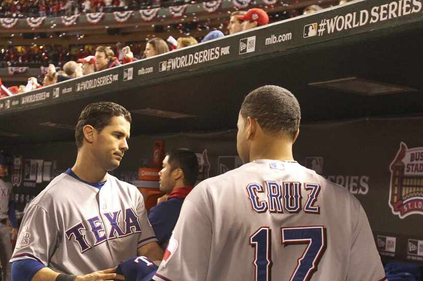 Texas Rangers Michael Young and Nelson Cruz leave the dugout after the final out of the...