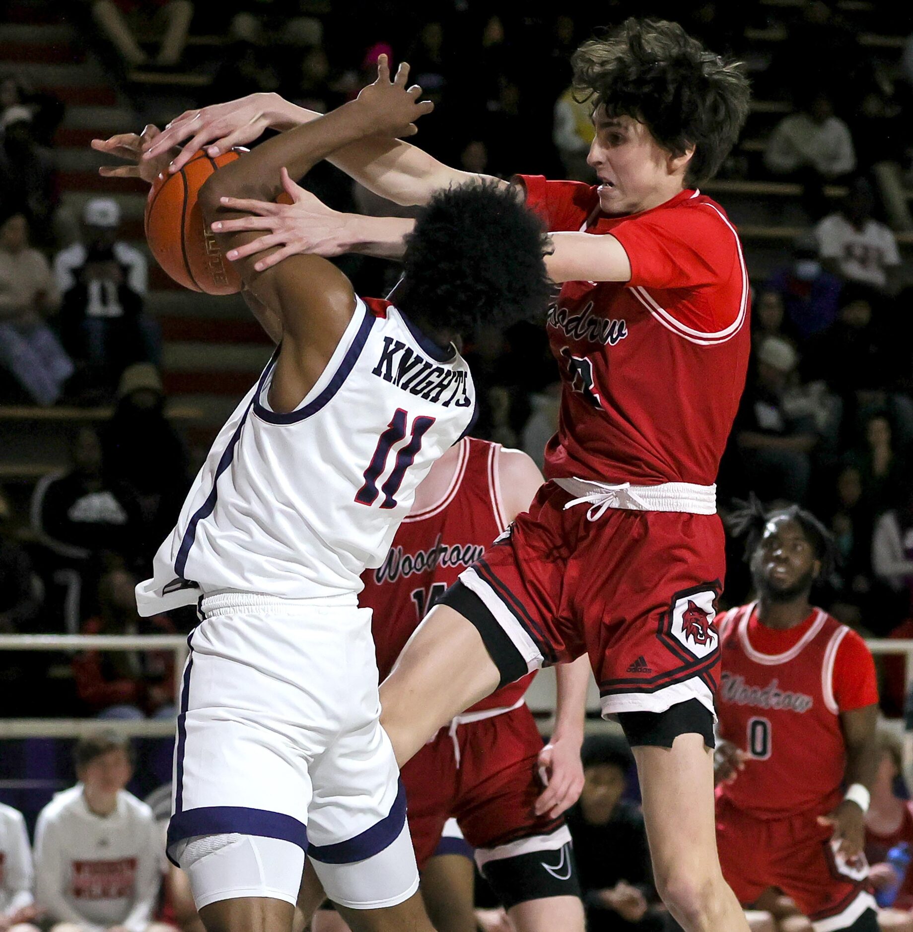 Kimball forward Barack Holland (11) gets fouled hard by Woodrow Wilson forward Jackson...