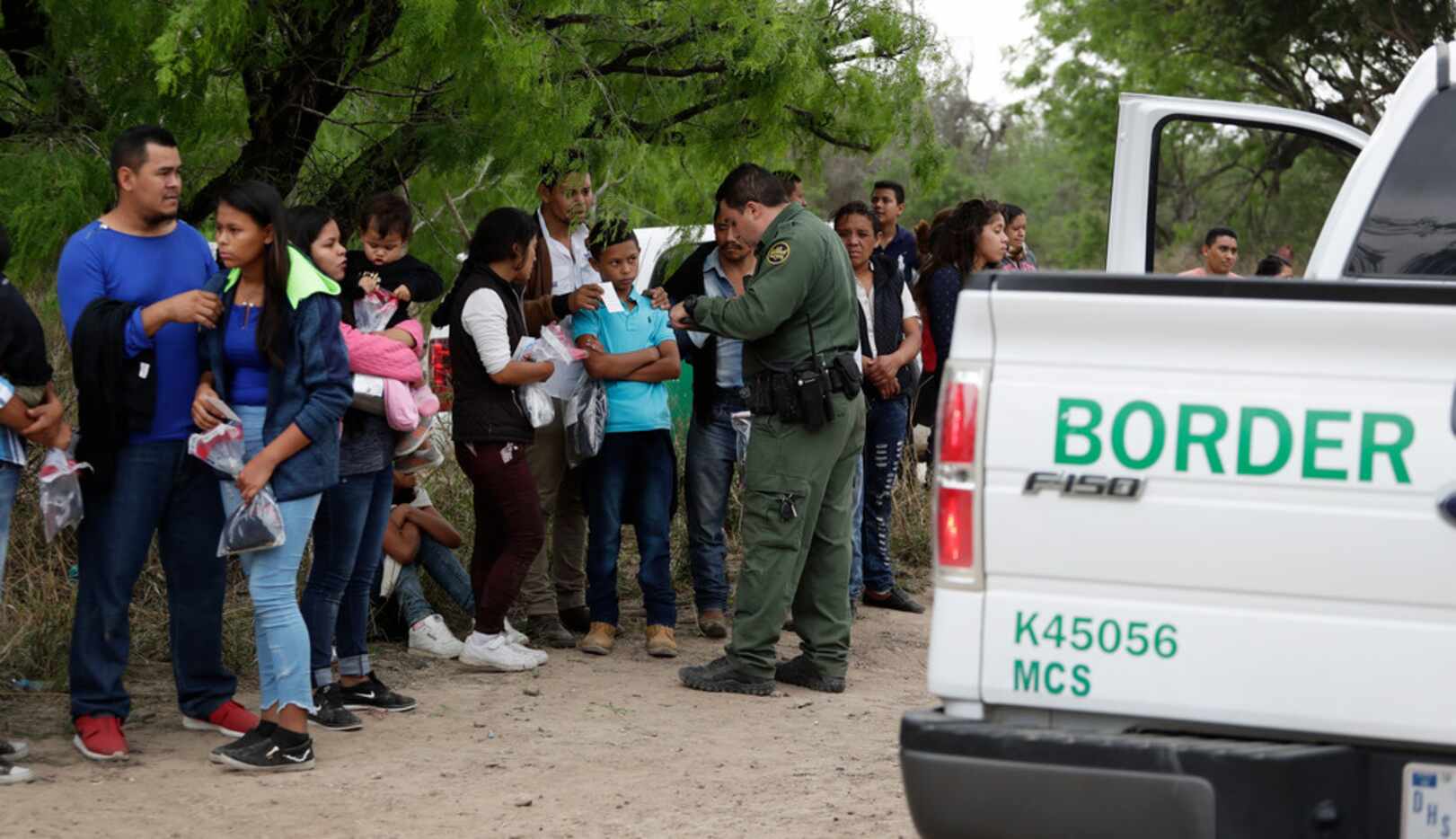 A Border Patrol agent near McAllen checked the names and documents of families who crossed...