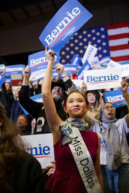 SMU law student Averie Bishop, who is Miss Dallas 2020, raises a sign as Democratic...