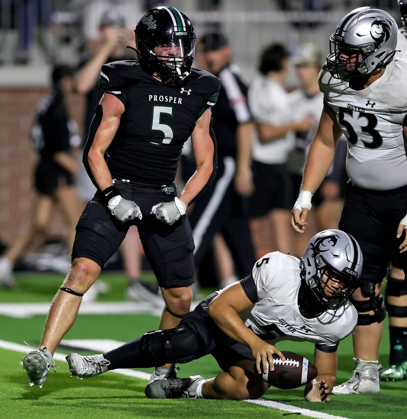 Prosper linebacker Jonah McClendon (left) gets excited from sacking Denton Guyer quarterback...