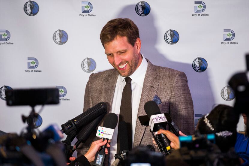 Retired Dallas Mavericks player Dirk Nowitzki answers questions from reporters after...