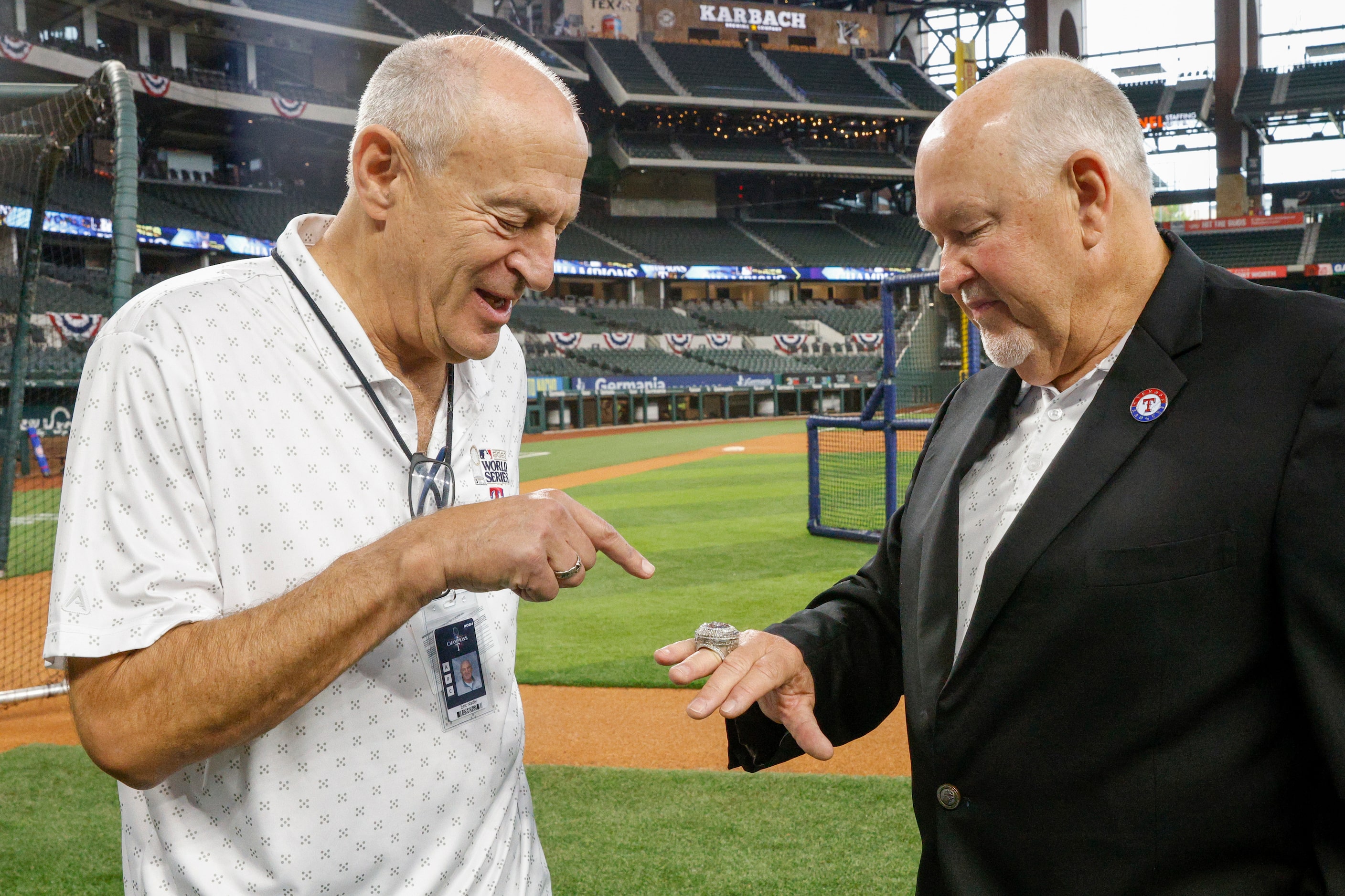 Texas Rangers broadcaster Eric Nadel checks out the World Series championship ring of Chuck...