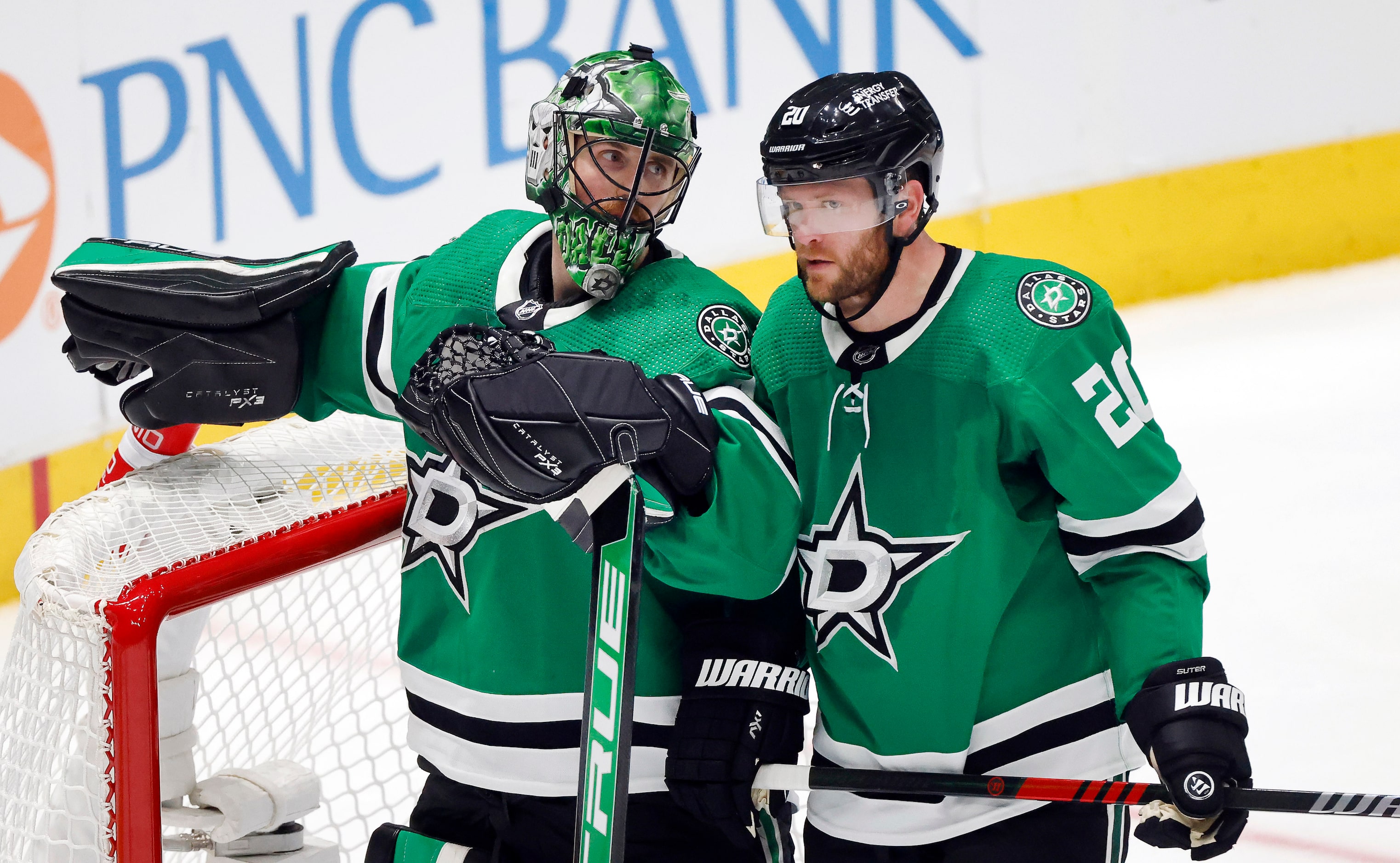 Dallas Stars defenseman Ryan Suter (20) confers with goaltender Scott Wedgewood (41) during...