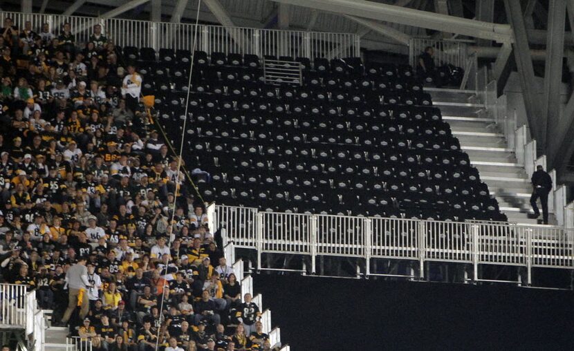 Seats that were ruled unsafe (section at top right) sit vacant besides some Arlington...