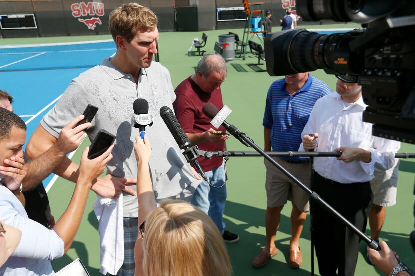 Dallas Mavericks forward Dirk Nowitzki talks with the media before practicing with Grand...