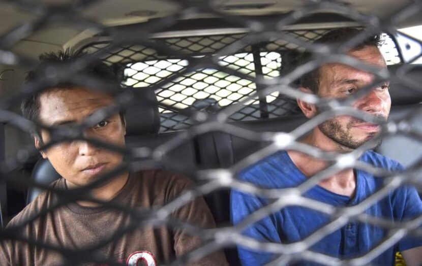 

Immigrants from Mexico and Honduras sit in the back of Brooks County sheriff’s Deputy...