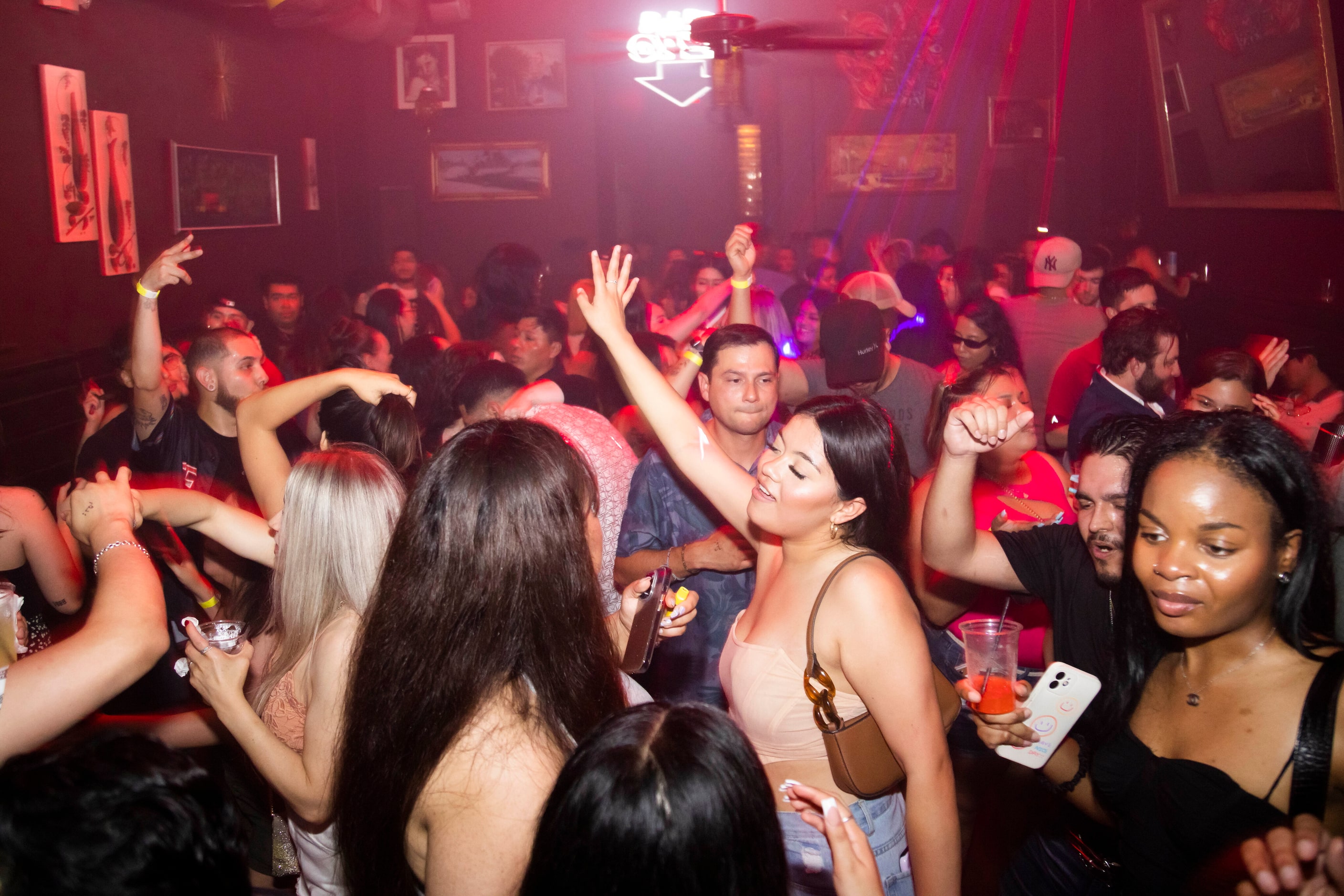 People dance during the Cumbia Dance Party event hosted at Cheapsteaks in the Deep Ellum...