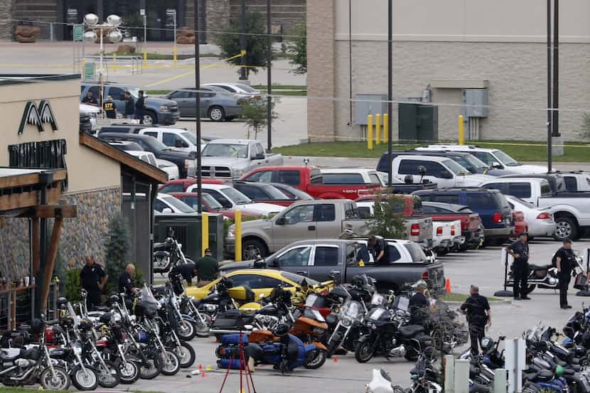 Authorities investigate the mass shooting at the Twin Peaks restaurant in Waco in this 2015...