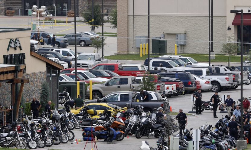 Authorities investigate the mass shooting at the Twin Peaks restaurant in Waco in this 2015...