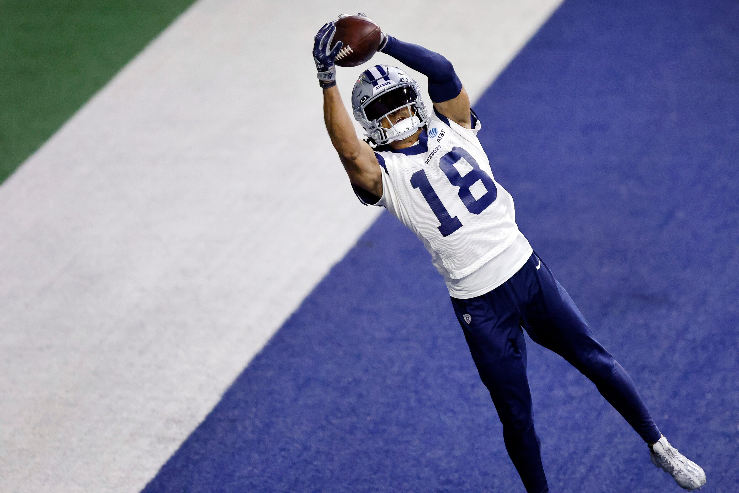 Dallas Cowboys wide receiver Jalen Tolbert (18) caches a pass in the back of the end zone...