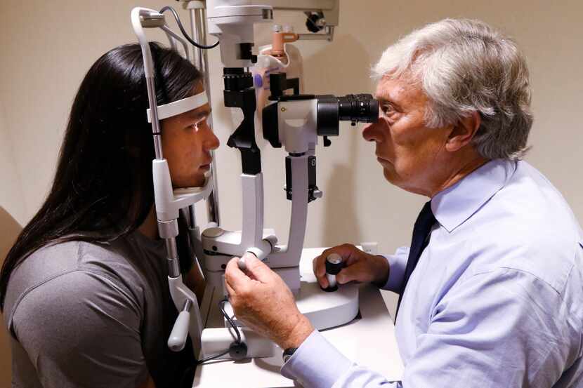 Mason Two Crow,  left,with Dr. David Birch at the Retina Foundation of the Southwest in...