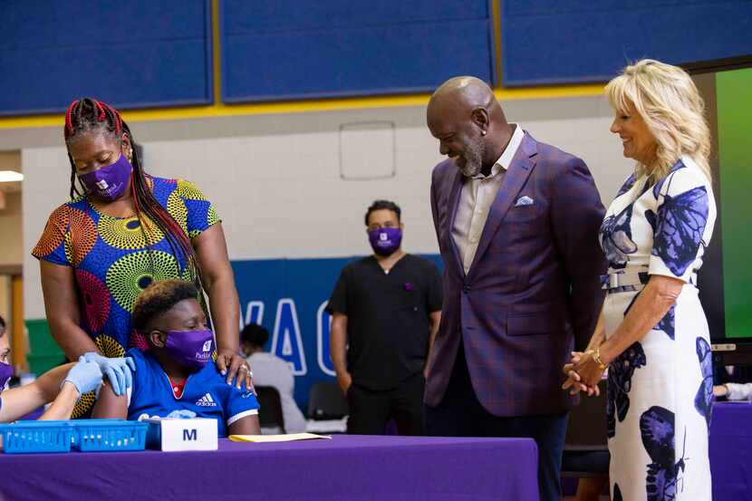 First lady Jill Biden and Dallas Cowboys legend Emmitt Smith watched as Ramona Williams held...