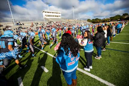 Thomas Jefferson High School football players run out onto the field for their homecoming...