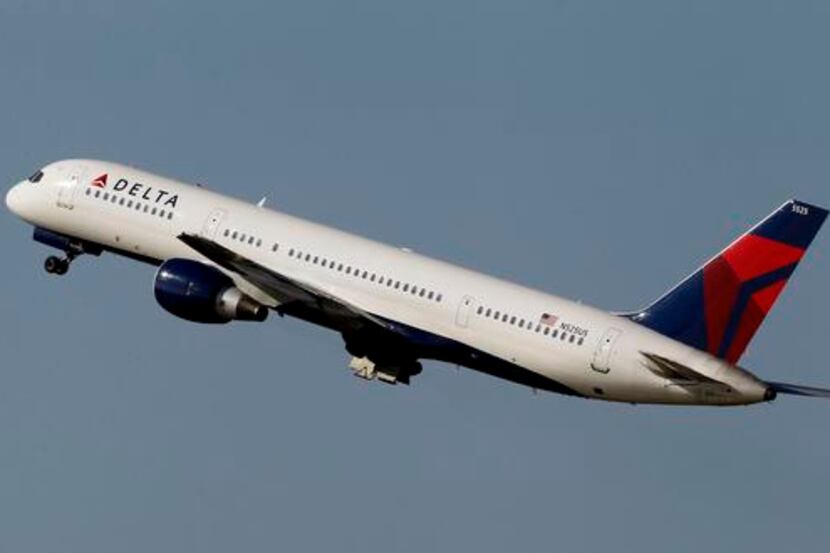 File-This photo taken Jan. 20, 2011, shows a Delta Airlines Boeing 757 taking off  in Tampa,...