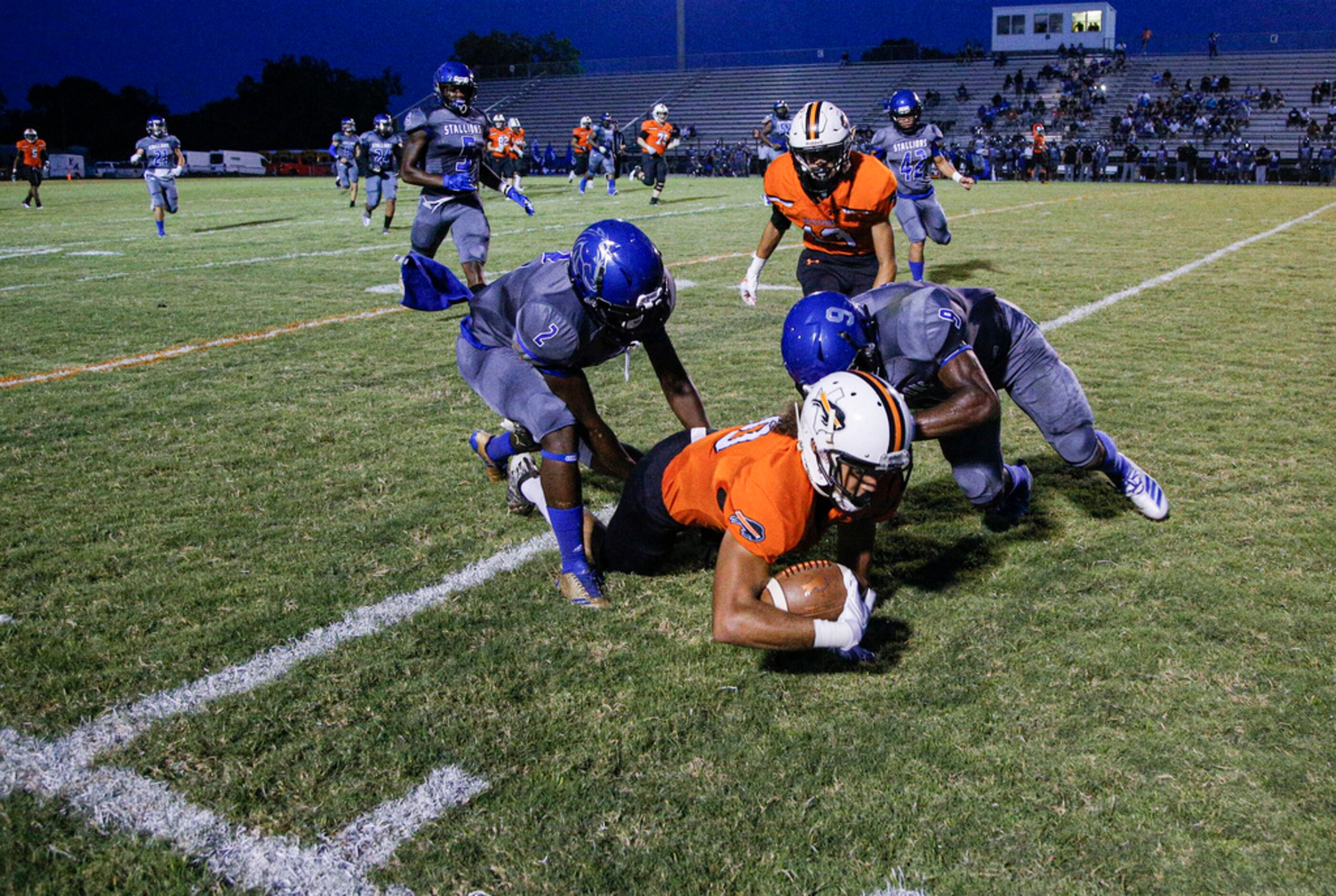 TXHSFB Haltom City junior wide receiver Derek Ocasio (80) is tackled by North Mesquite...