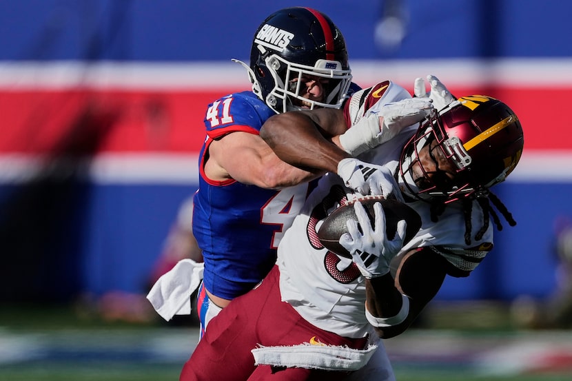 Washington Commanders wide receiver Noah Brown (85) comes down with a catch against New York...