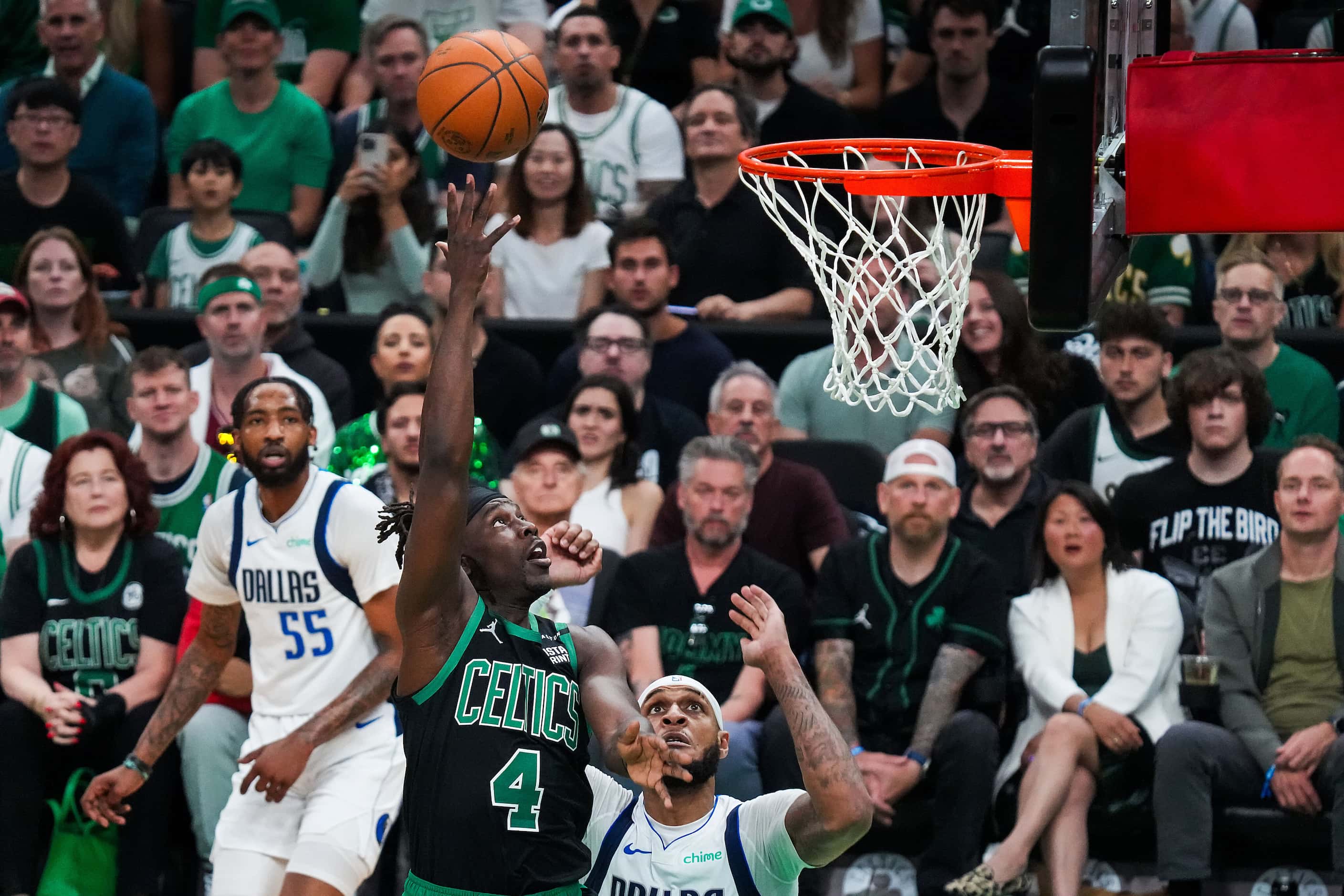 Boston Celtics guard Jrue Holiday (4) scores over Dallas Mavericks center Daniel Gafford...