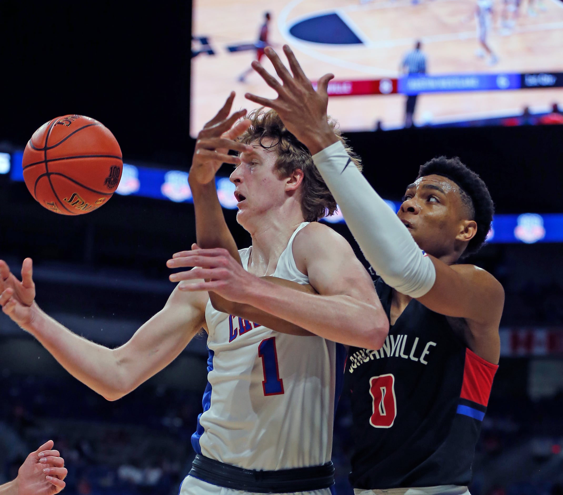 Duncanville Zhuric Phelps #0 battles Westlake Cade Mankle #1 for a rebound. UIL boys Class...