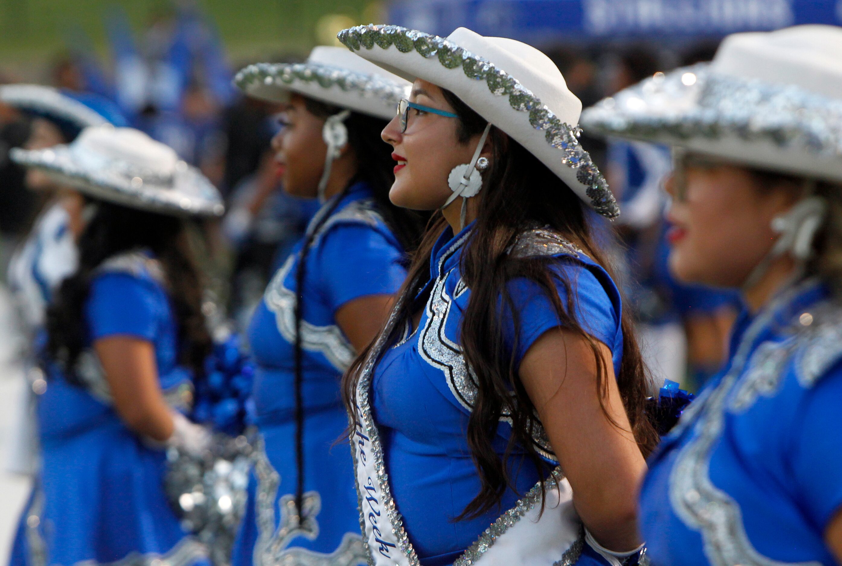 Members of the North Mesquite drill team await their turn to go onto the field for pre-game...