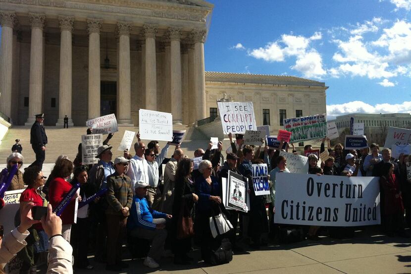 
Protesters rally outside the Supreme Court against the justices decision in the Citizens...