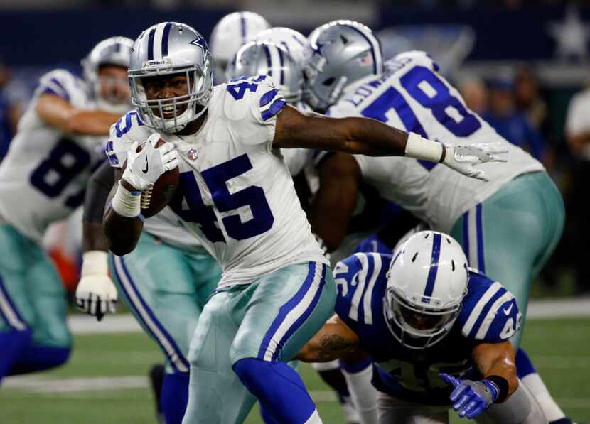 Dallas Cowboys fullback Rod Smith (45) breaks a tackle attempt by Indianapolis Colts...