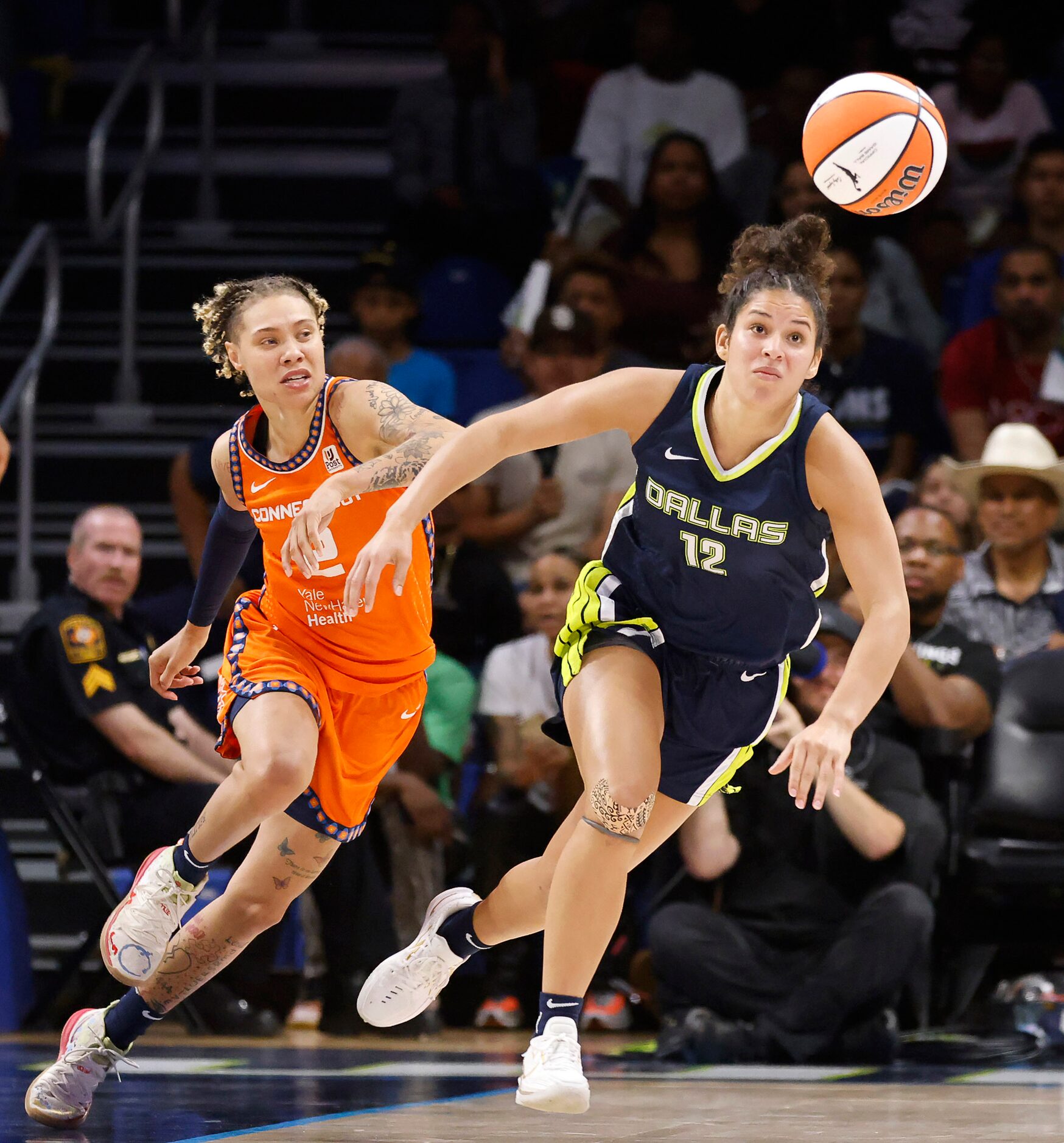 Dallas Wings guard Veronica Burton (12) and Connecticut Sun guard Natisha Hiedeman (2) chase...