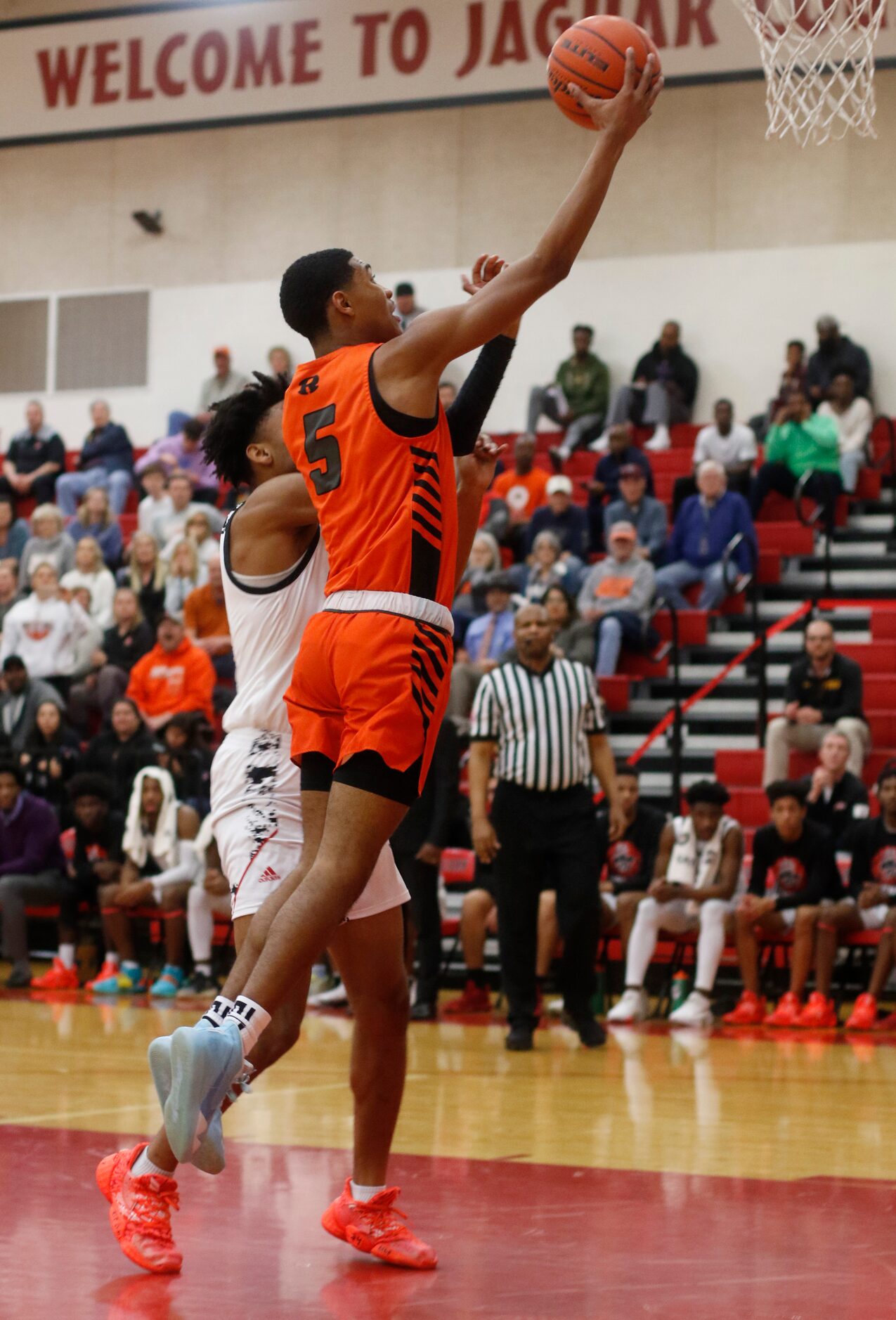 Rockwall's Jamal Wiley (5) drives to the basket for two of his first half points as he is...