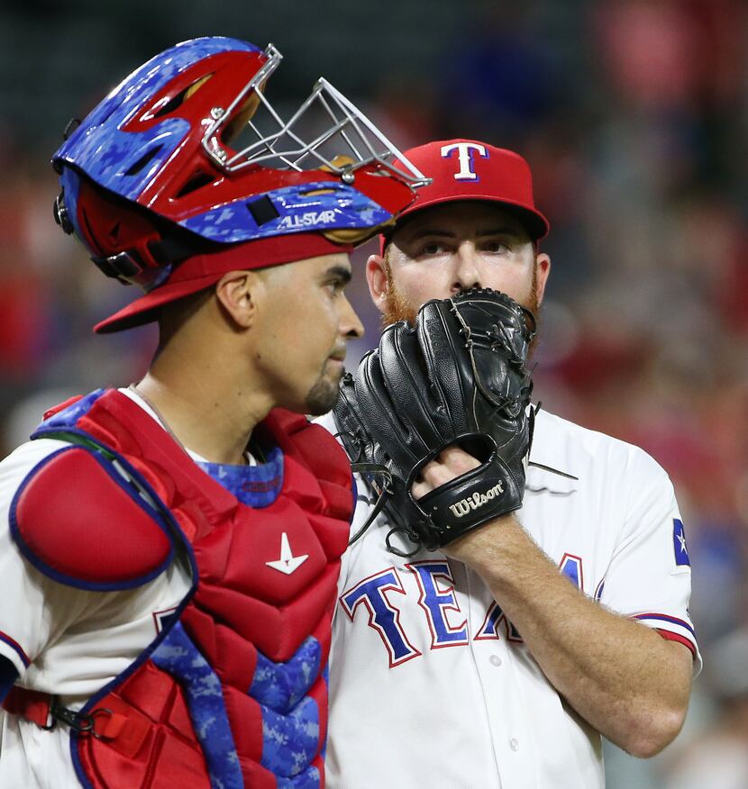 Texas Rangers closing pitcher Sam Dyson (47) and catcher Robinson Chirinos (61) after Dyson...
