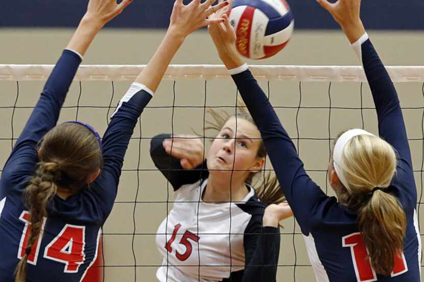 Lovejoy High School's middle blocker (15) Sarah Langs attempts to hit the volleyball between...