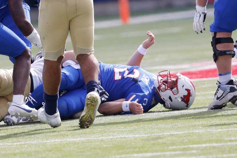 SMU quarterback Preston Stone (2) is sacked and injures during the first half of an NCAA...