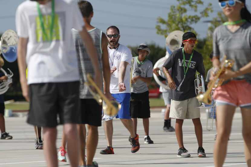 Assistant band director Matthew Schaul helped lead marching band practice in early August at...