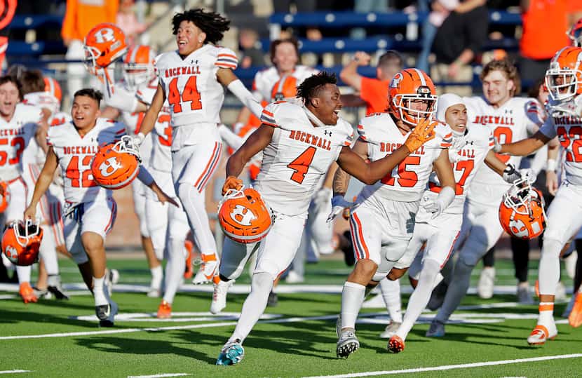 The Rockwall High School football team storms the field after holding on to win 46-43 as...