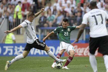Mexico's forward Hirving Lozano (C) shoots and scores the opening goal  during the Russia...