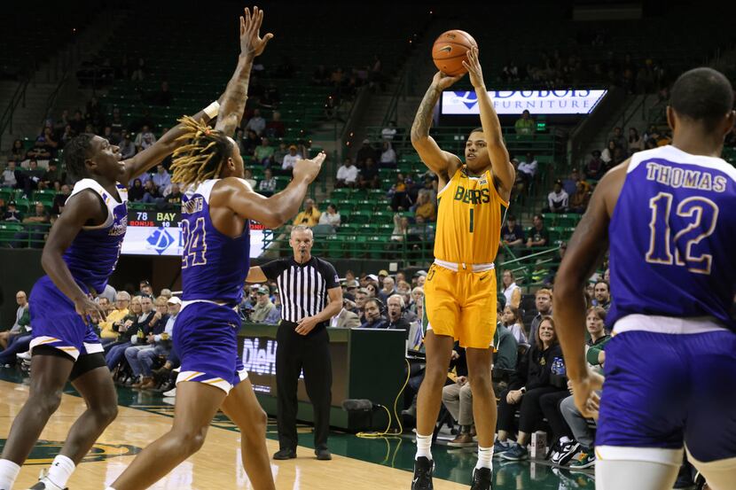 Baylor guard Keyonte George (1) shoots in front ot McNeese State forward Christian Shumate...