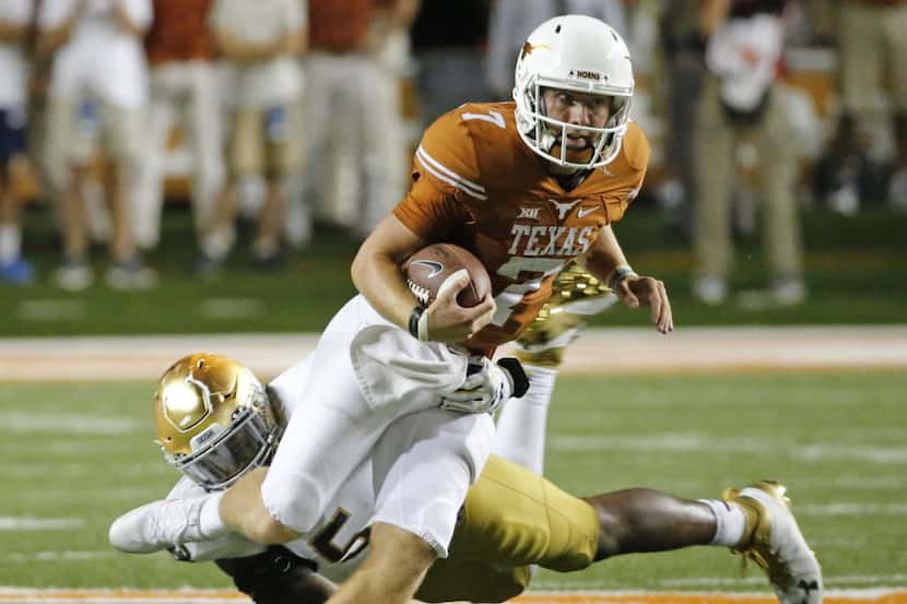 Texas quarterback Shane Buechele (7) scrambles for yardage in the fourth quarter during the...