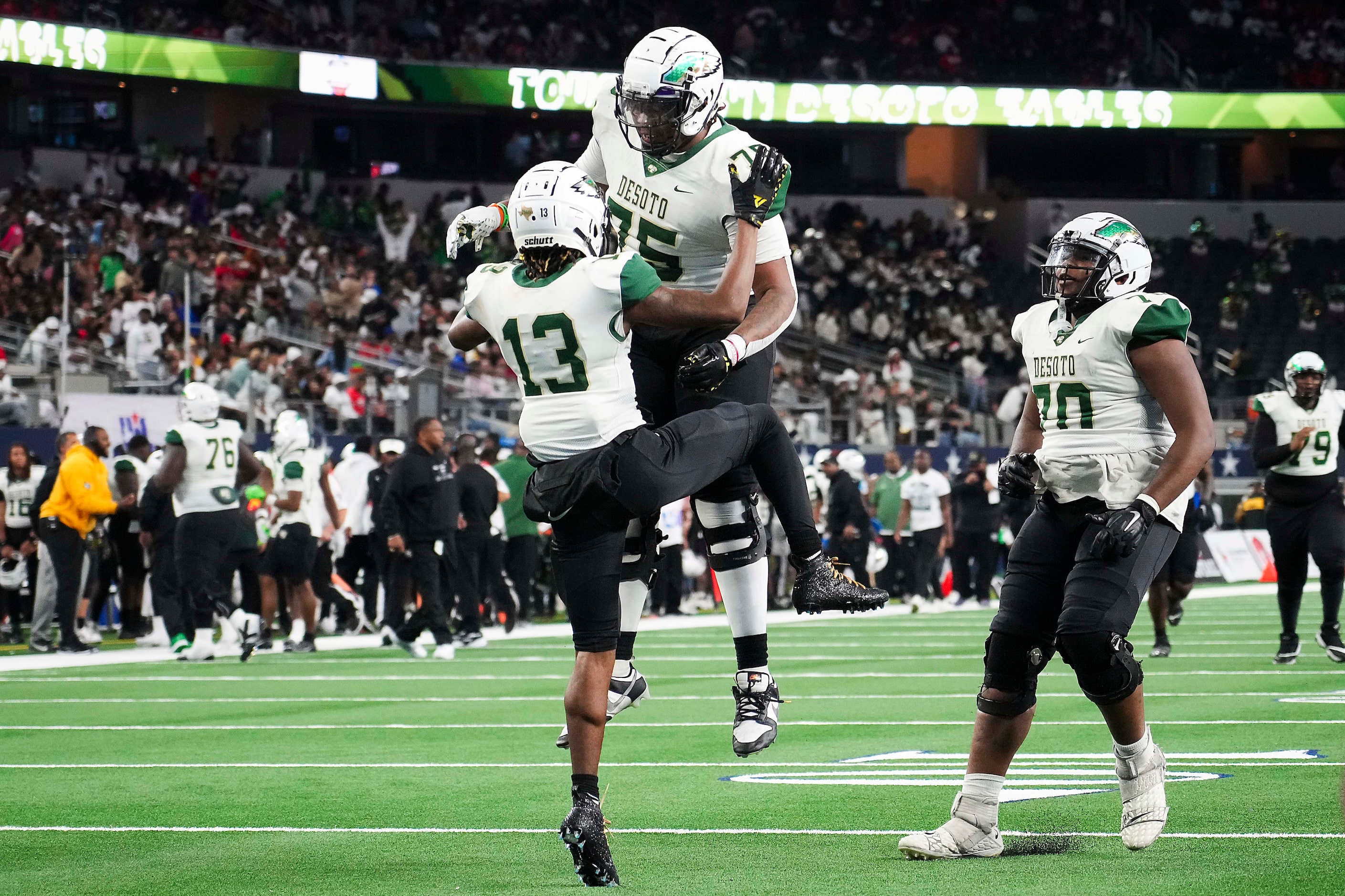 DeSoto wide receiver Daylon Singleton (13) celebrates with offensive lineman Ronnell Mclain...