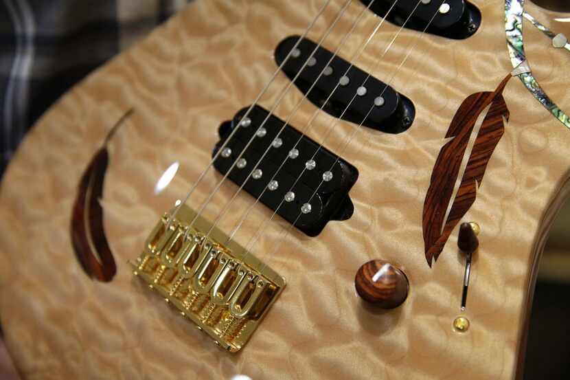 
A Suhr carved top guitar with custom inlays Some of their pricey electric guitars sell for...