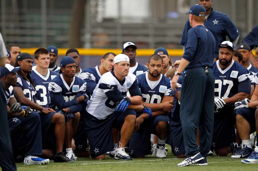 Cowboys huddle up for a talk from coach Jason Garrett at training camp in 2015.