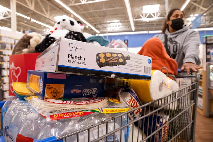 Yezenia Rivera pushes a cart with 9-month-old Jenni Morales as she shops ahead of a winter...