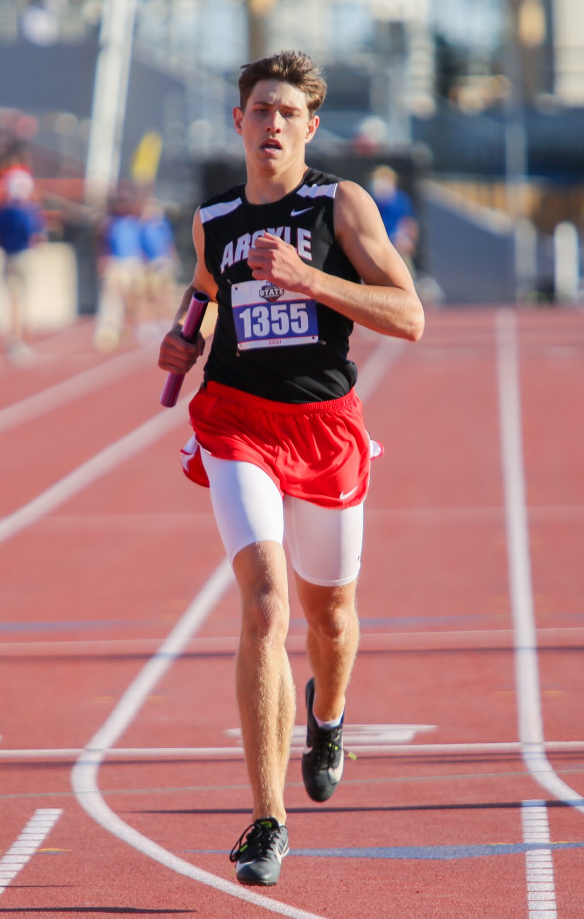 Argyle's Jett Copeland crosses the line at fifth place during their 4A boys 4x200 relay...