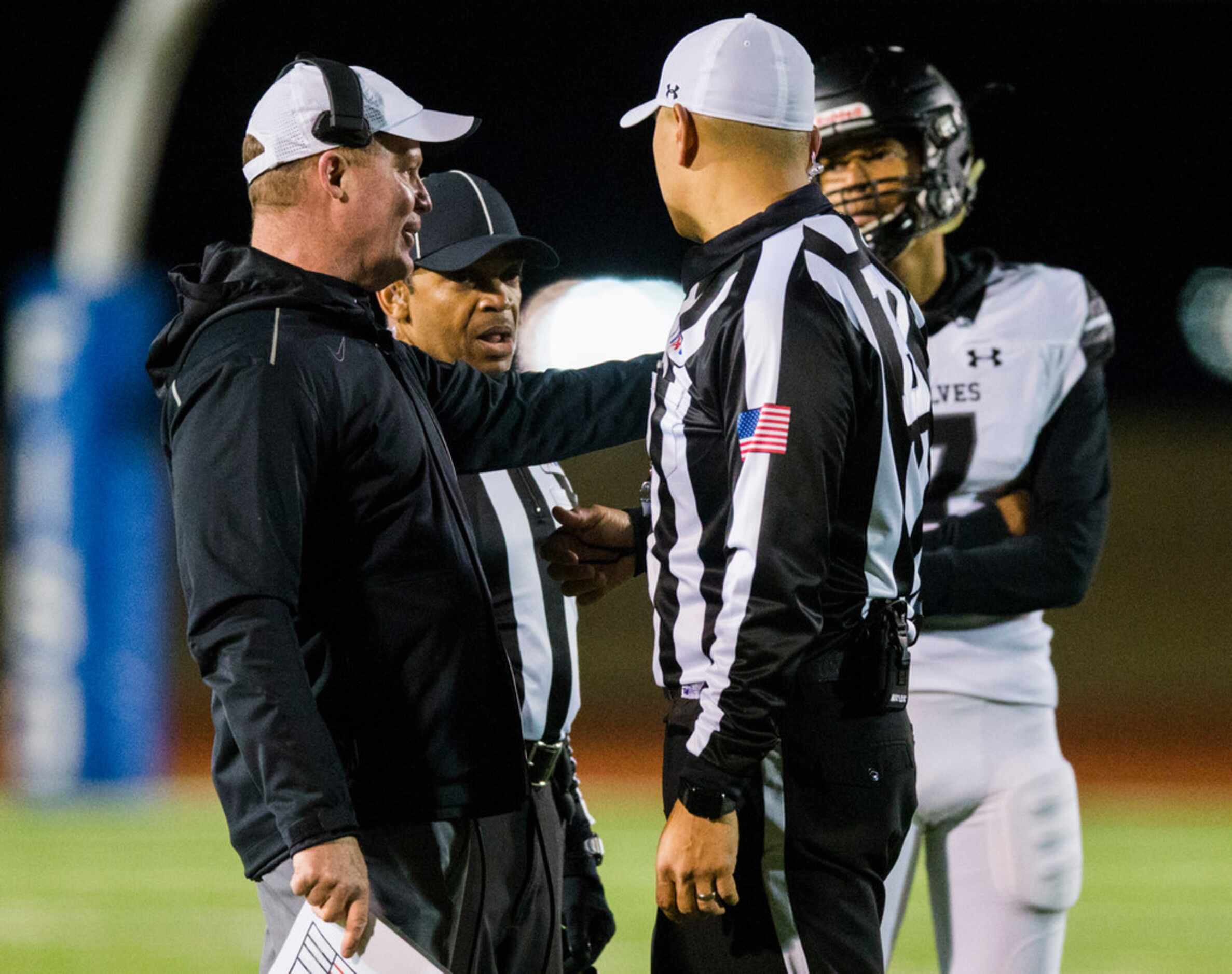 Frisco Independence head coach Kyle Story (left) disputes a double personal foul call during...