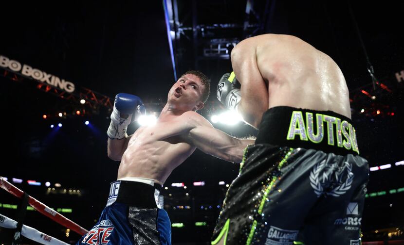 ARLINGTON, TX - SEPTEMBER 17: Canelo Alvarez, left, fights with Liam Smith, right, during...
