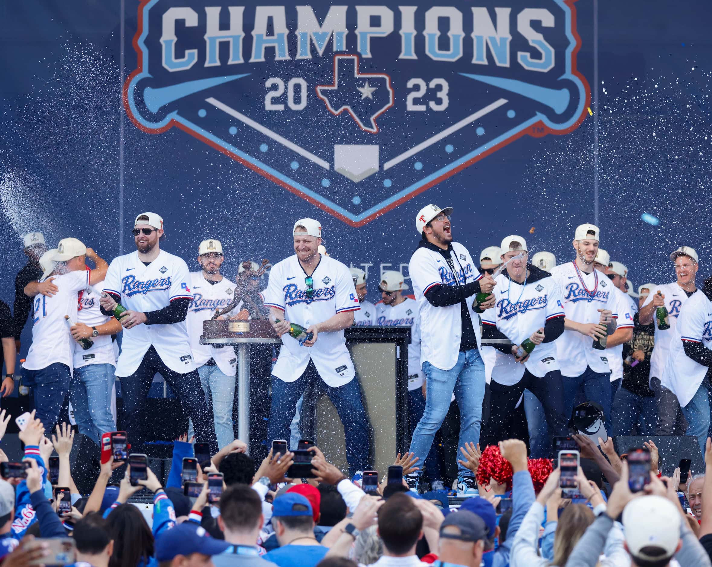 Texas Rangers players spray champagne during post-parade public celebration on, Friday, Nov....