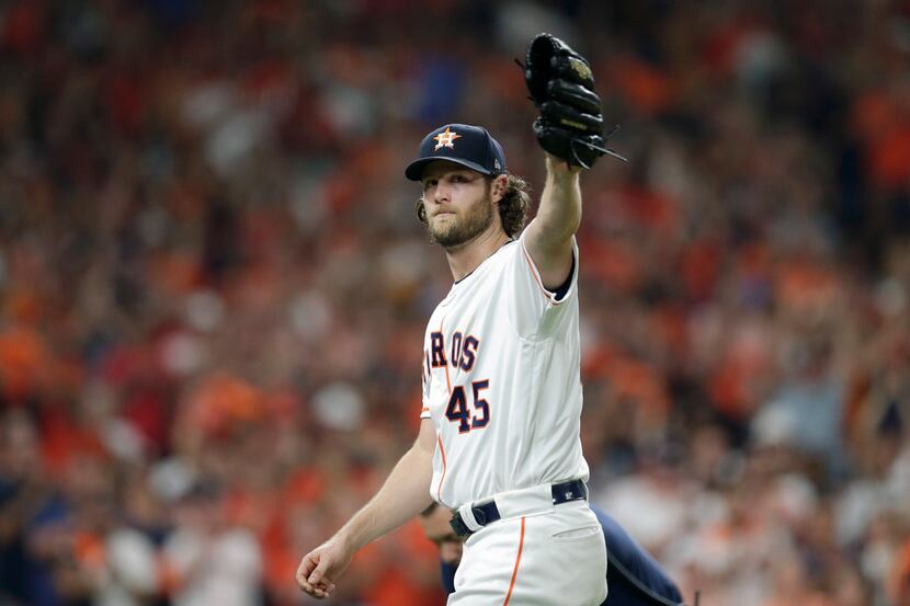 Houston Astros starting pitcher Gerrit Cole waves to fans as he leaves during the eighth...