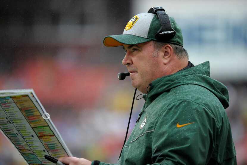 FILE - Green Bay Packers head coach Mike McCarthy looks at his play sheet during a game...